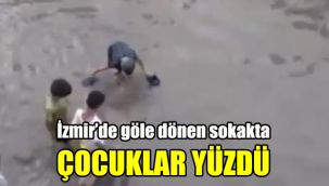 İzmir’de göle dönen sokakta çocuklar yüzdü