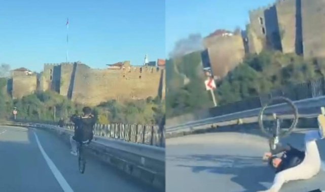 Bisikleti ile tek teker üzerine yolda gitmeye çalışırken az kalsın otomobilin altında kalıyordu